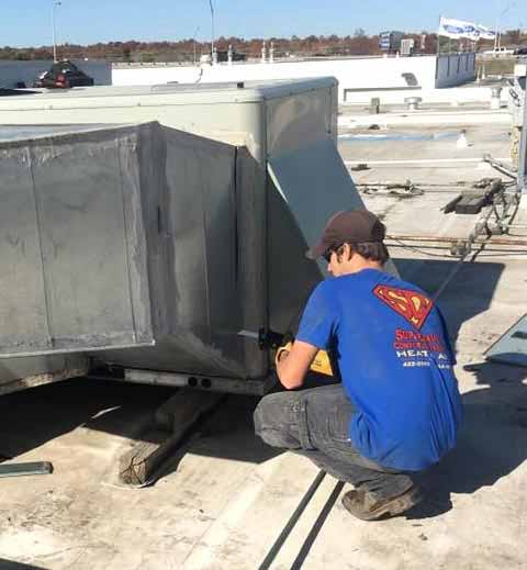 Rooftop HVAC repair by a qualified Super Dave's technician.